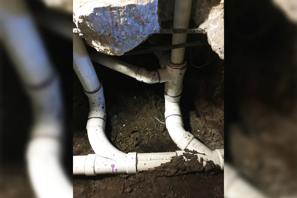New Schedule 40 PVC sewer pipe fittings and drain line connections installed beneath a concrete slab during a sewer line repair by EverydayPlumber.com in Tampa Bay