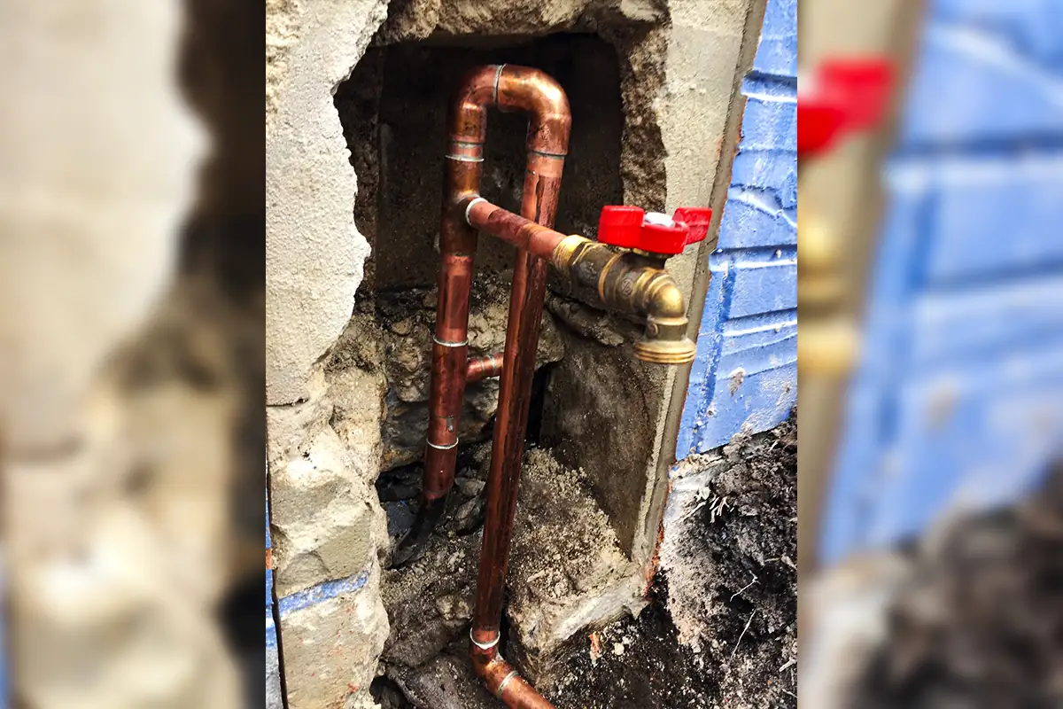 Copper pipe repair through concrete wall cutout with red ball valve shutoff — pipe repair wall access — EVERYDAYPLUMBER.com Tampa Bay