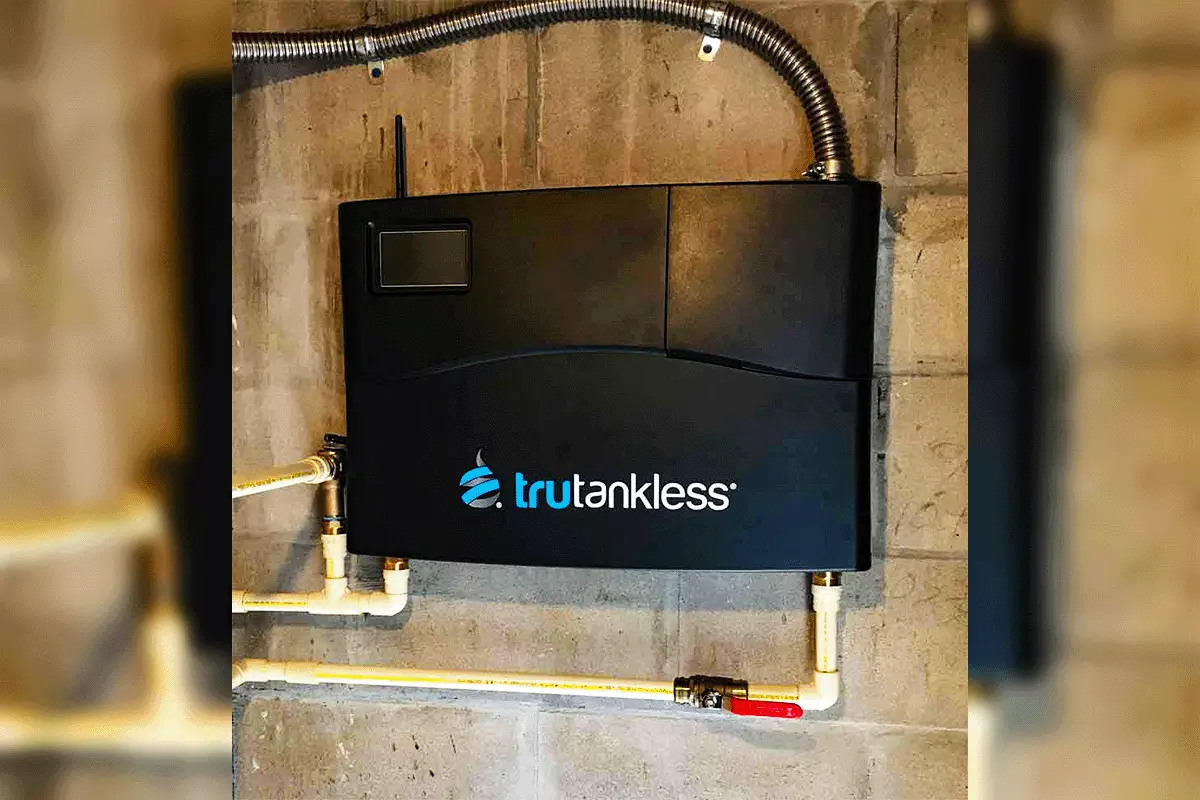 Trutankless electric tankless water heater mounted on concrete block wall with PEX supply lines — electric tankless water heater installation Tampa