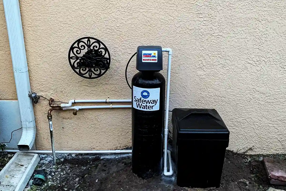 Whole-house water softener and brine tank installed on stucco exterior of Tampa home