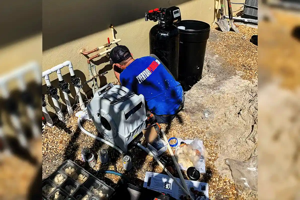 EVERYDAYPLUMBER.com technician installing whole-house water softener system at Tampa Bay home — water treatment installation in progress
