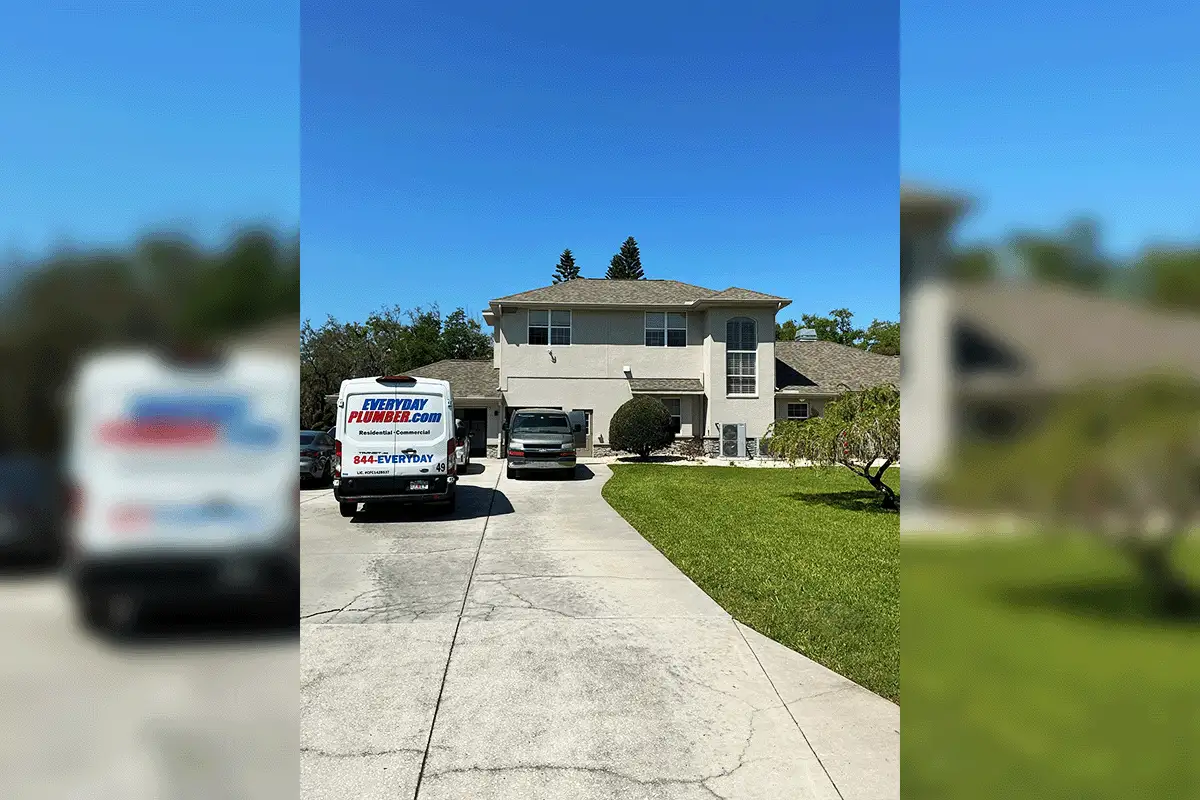EverydayPlumber.com branded service van parked at a large Tampa Bay residential home — Residential and Commercial plumbing, 844-EVERYDAY, license CFC1428537 visible, representing over a thousand five-star Google reviews and family-owned service across Hillsborough, Pinellas, and Pasco counties since 2012