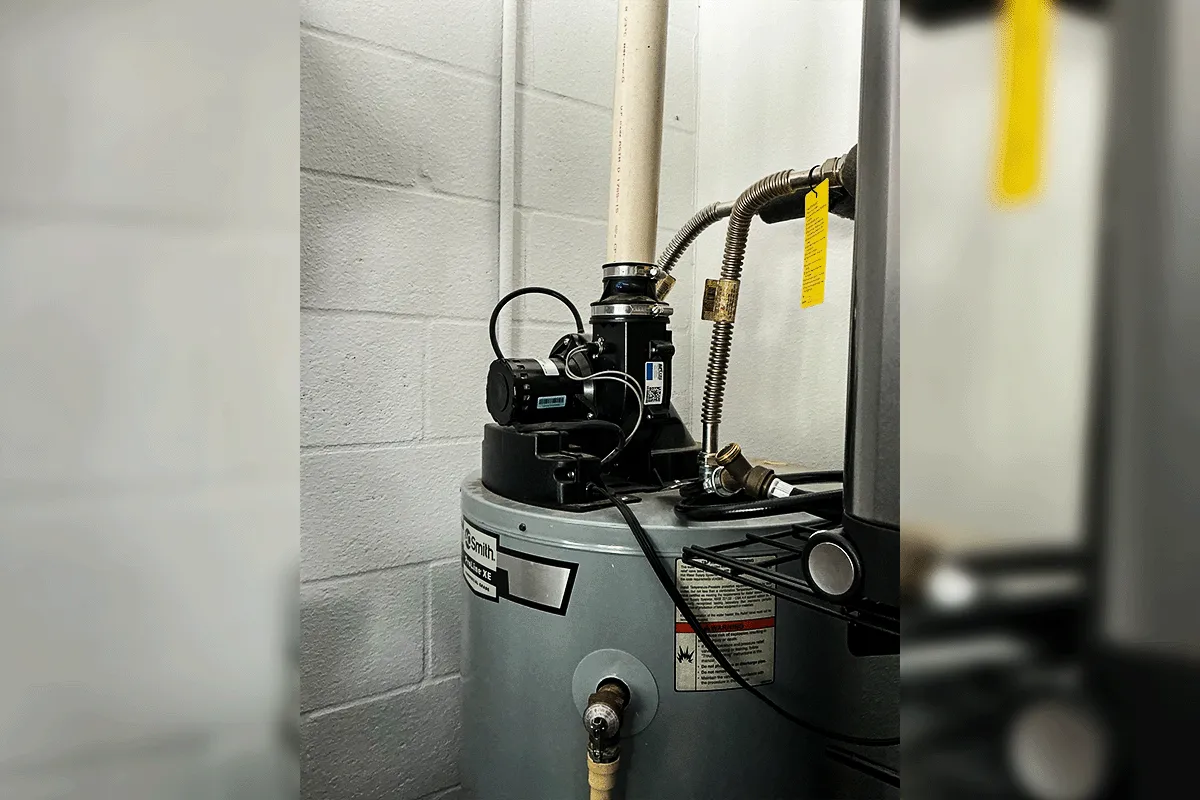 A.O. Smith commercial water heater with hot water recirculation pump installed on top at a Tampa Bay commercial property — showing professional connections including gas flex line, PVC supply lines, and recirculation system for continuous hot water delivery in a commercial setting