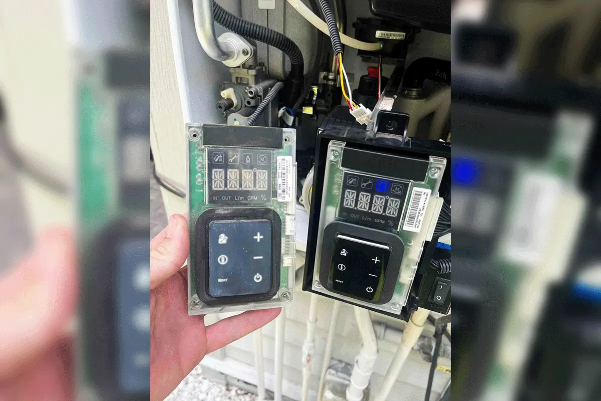 Failed and replacement Rinnai tankless water heater control boards compared during a Tampa Bay service call — EverydayPlumber.com technician holding the failed board next to the newly installed replacement unit, showing the component-level diagnostic and repair process for tankless water heaters