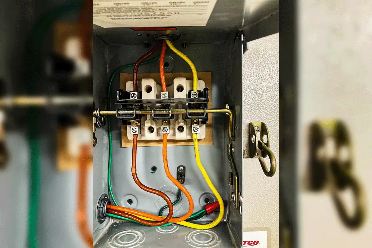 Open electrical disconnect box during a water heater service call in Tampa Bay — showing color-coded wiring, terminal block connections, and thermal cutoff components inspected as part of EverydayPlumber.com's licensed diagnostic process for electric water heater failures