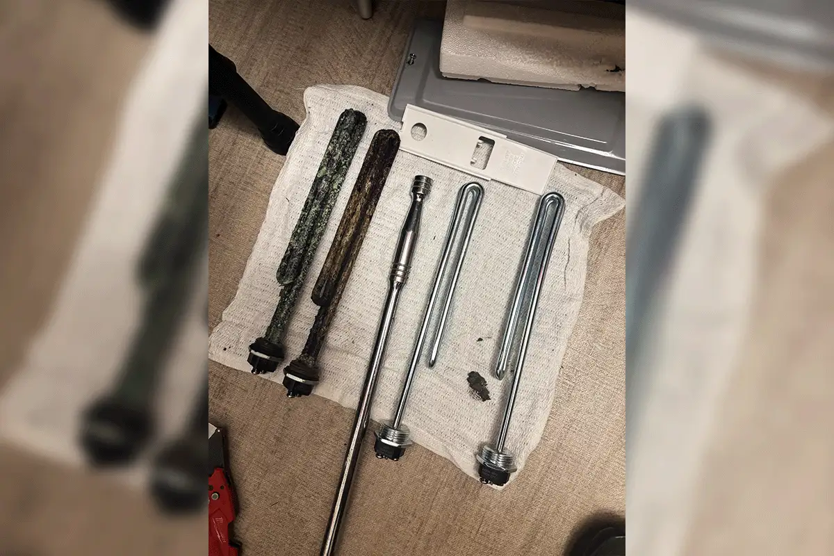 Failed and corroded water heater heating elements removed during an EverydayPlumber.com service call in Tampa Bay — two severely degraded elements on the left alongside new replacement elements on the right, showing the component-level repair approach for electric tank water heaters