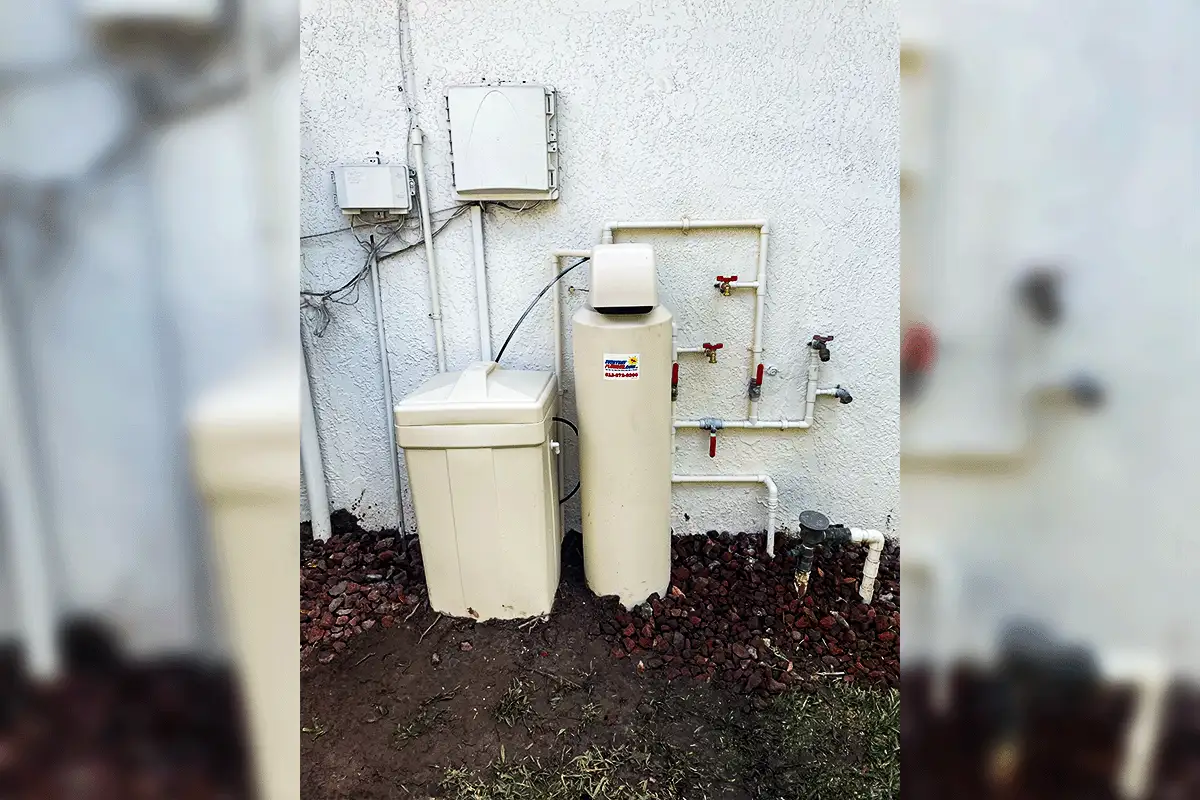Whole-house water softener and brine tank installed on exterior wall of Tampa home with bypass valve plumbing