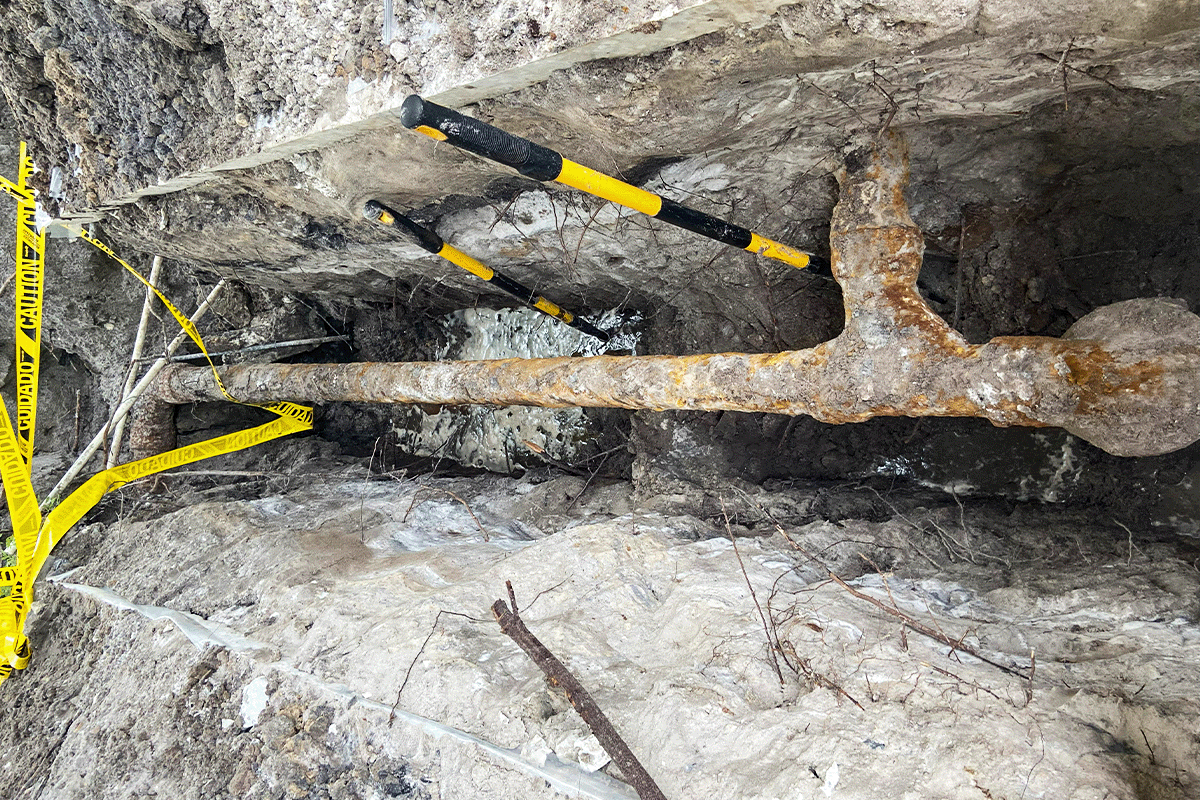 Corroded cast iron sewer pipe exposed during excavation beneath a St. Petersburg Florida home — EVERYDAYPLUMBER.com pipe repair and replacement