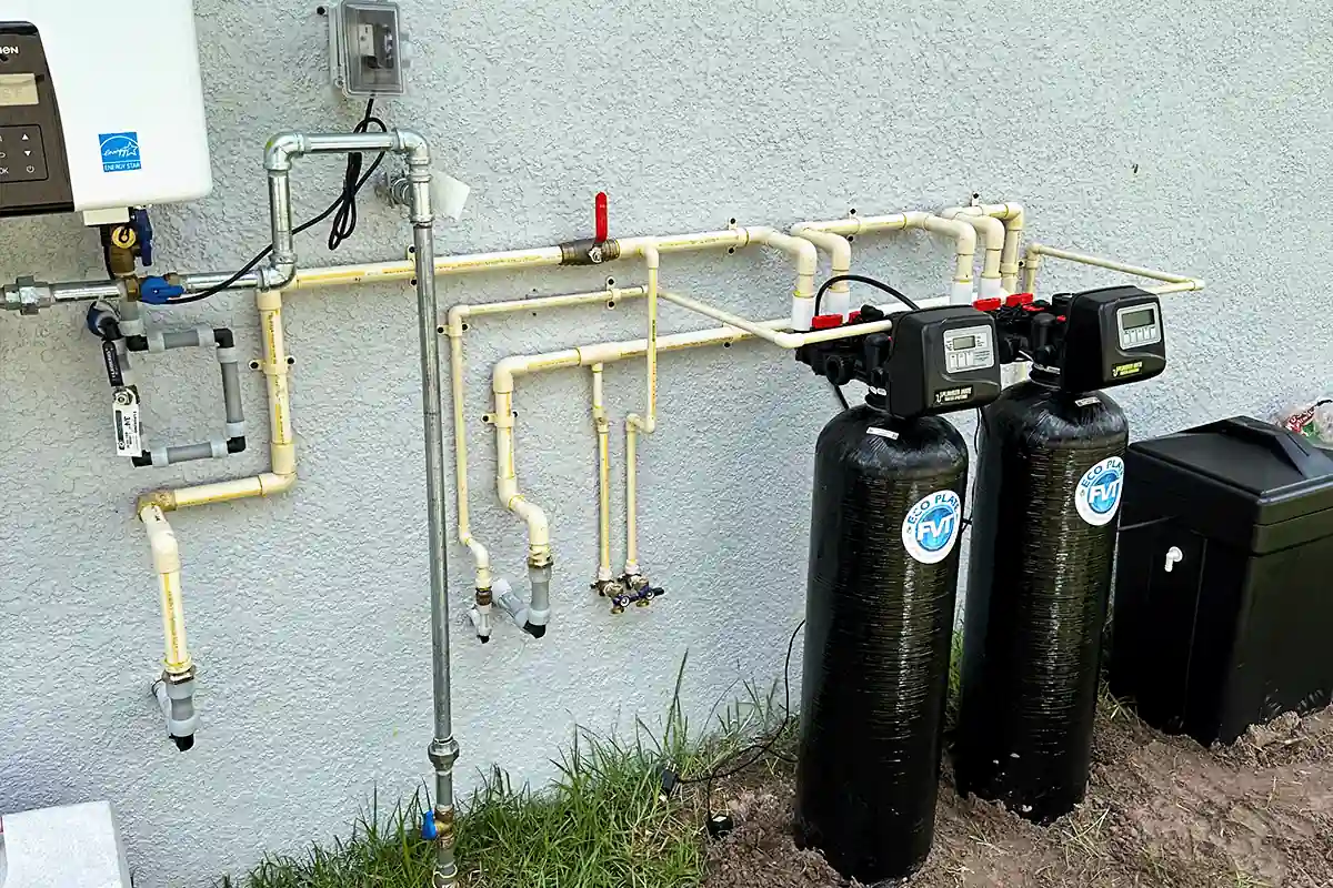 Whole-home water softener and filtration system installed on exterior wall — water treatment services in Clearwater FL — EVERYDAYPLUMBER.com