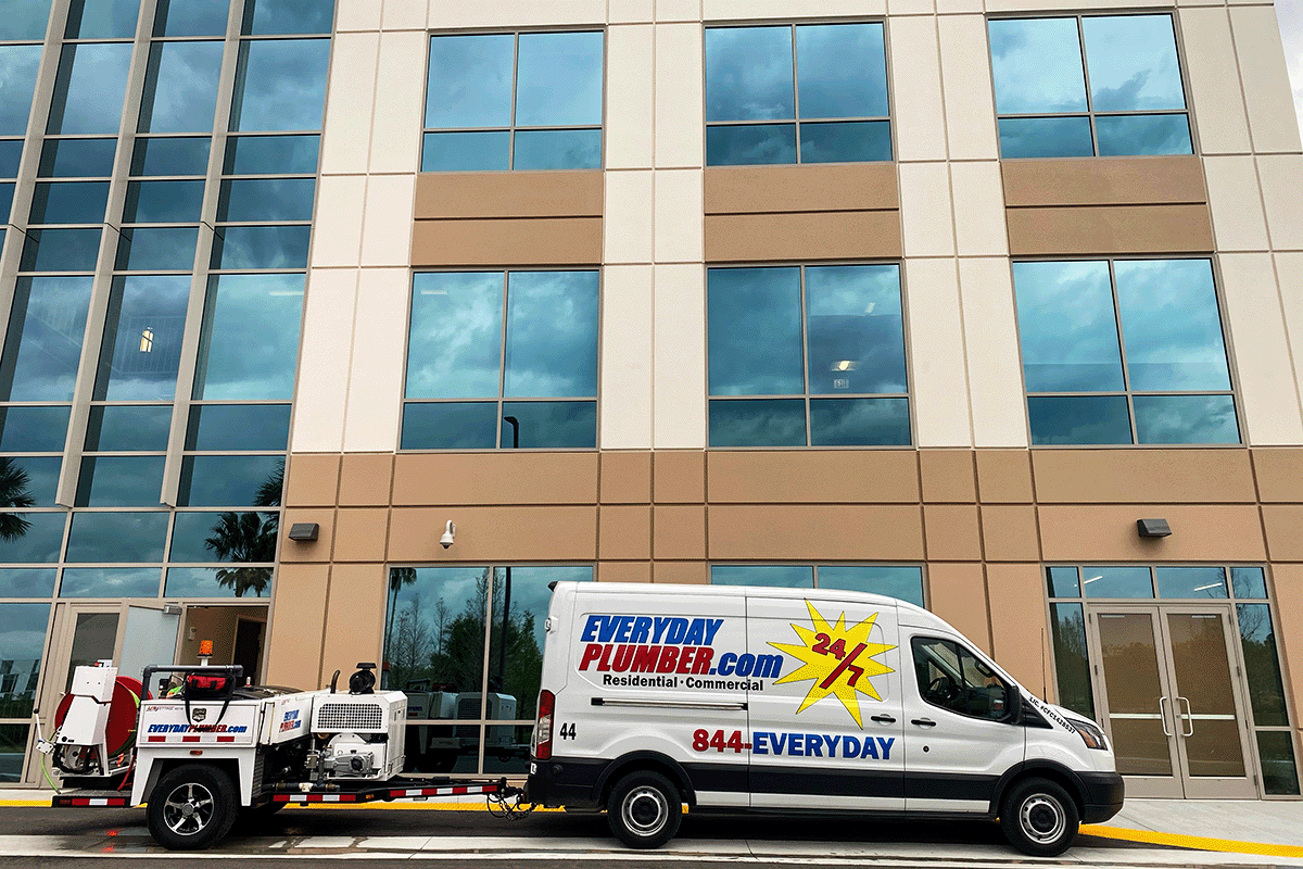 EVERYDAYPLUMBER.com van and hydro jetting trailer outside a commercial building in St. Petersburg Florida — licensed commercial plumbers serving Pinellas County