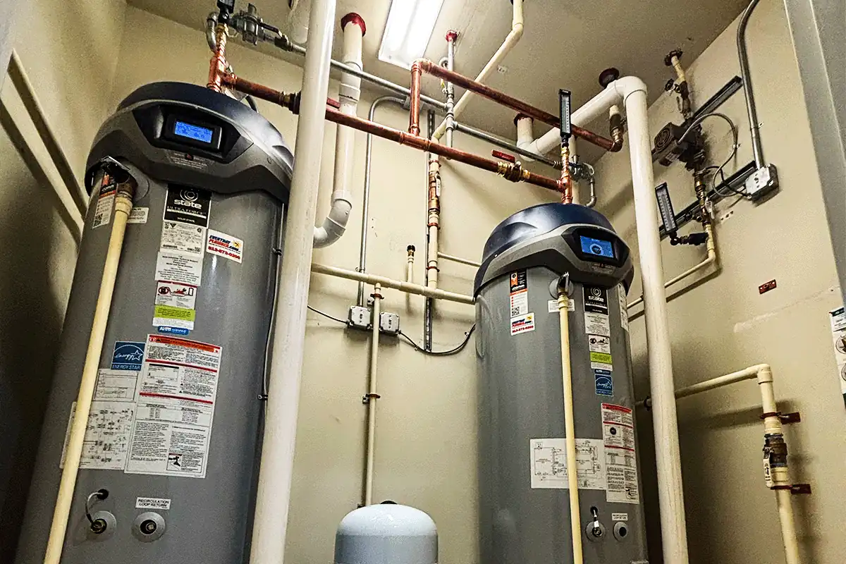 Dual commercial water heater installation with copper supply lines and recirculation piping — commercial plumbing Wesley Chapel — EVERYDAYPLUMBER.com Wesley Chapel