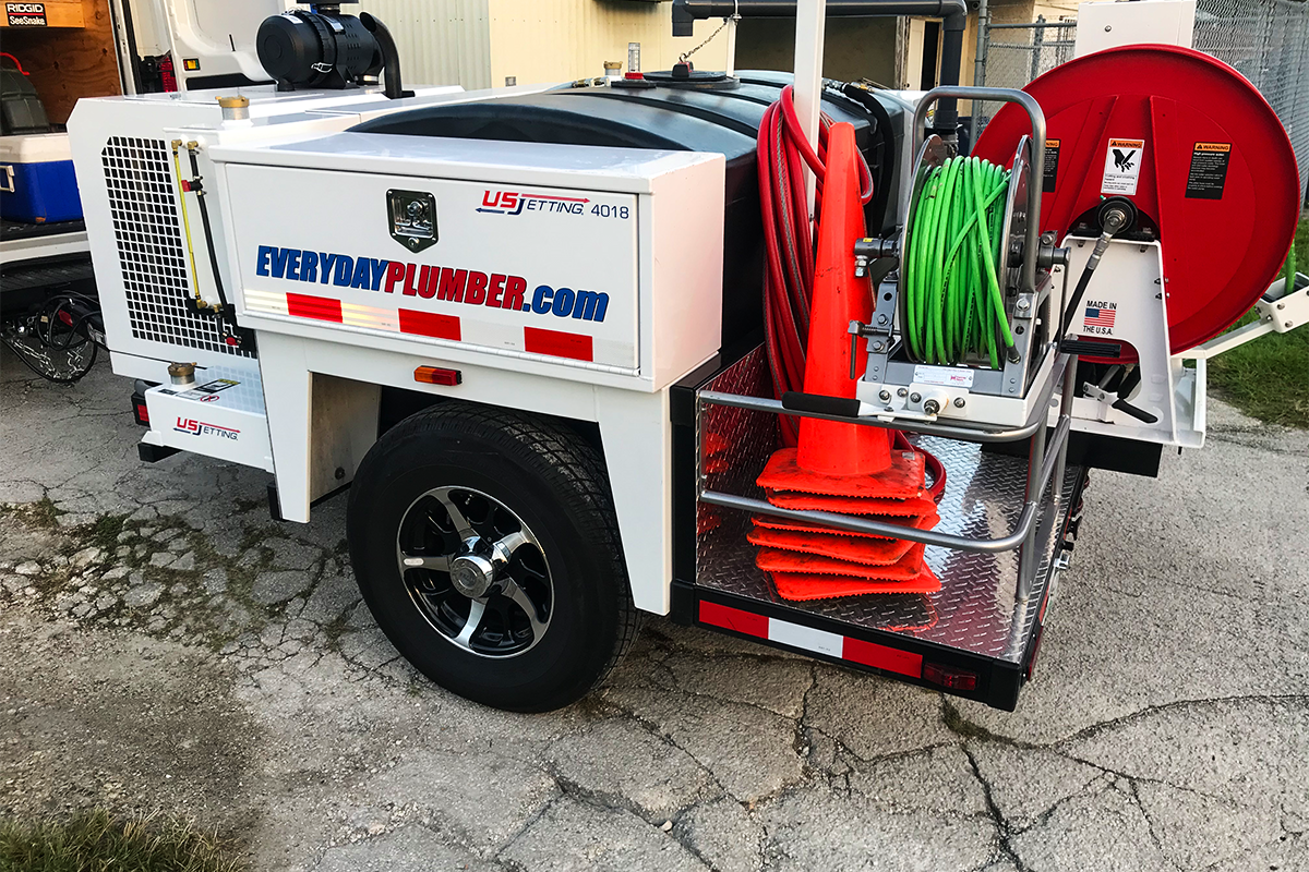 EVERYDAYPLUMBER.com branded US Jetting hydro jetting trailer with hose reel and equipment — professional plumbing services Carrollwood FL — EVERYDAYPLUMBER.com Tampa Bay<br />

