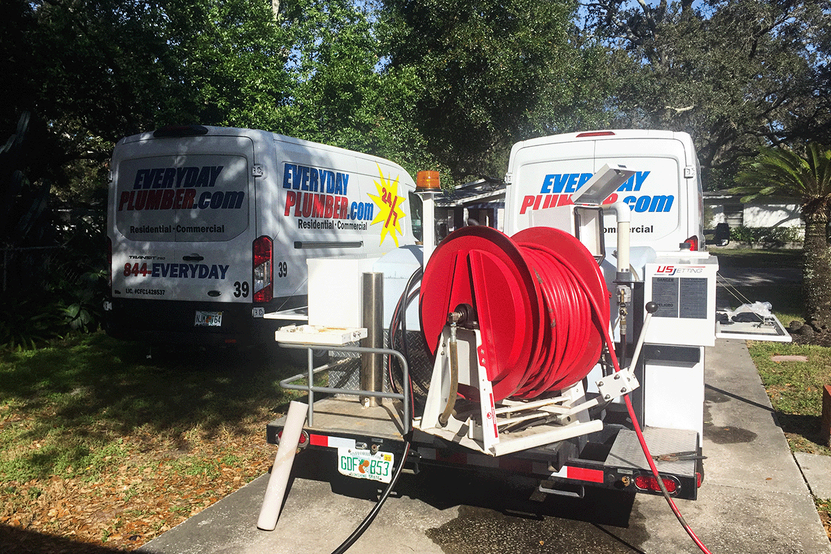 EVERYDAYPLUMBER.com service vans and hydro jetting trailer staged for drain cleaning service in St. Petersburg Florida — Pinellas County plumbers