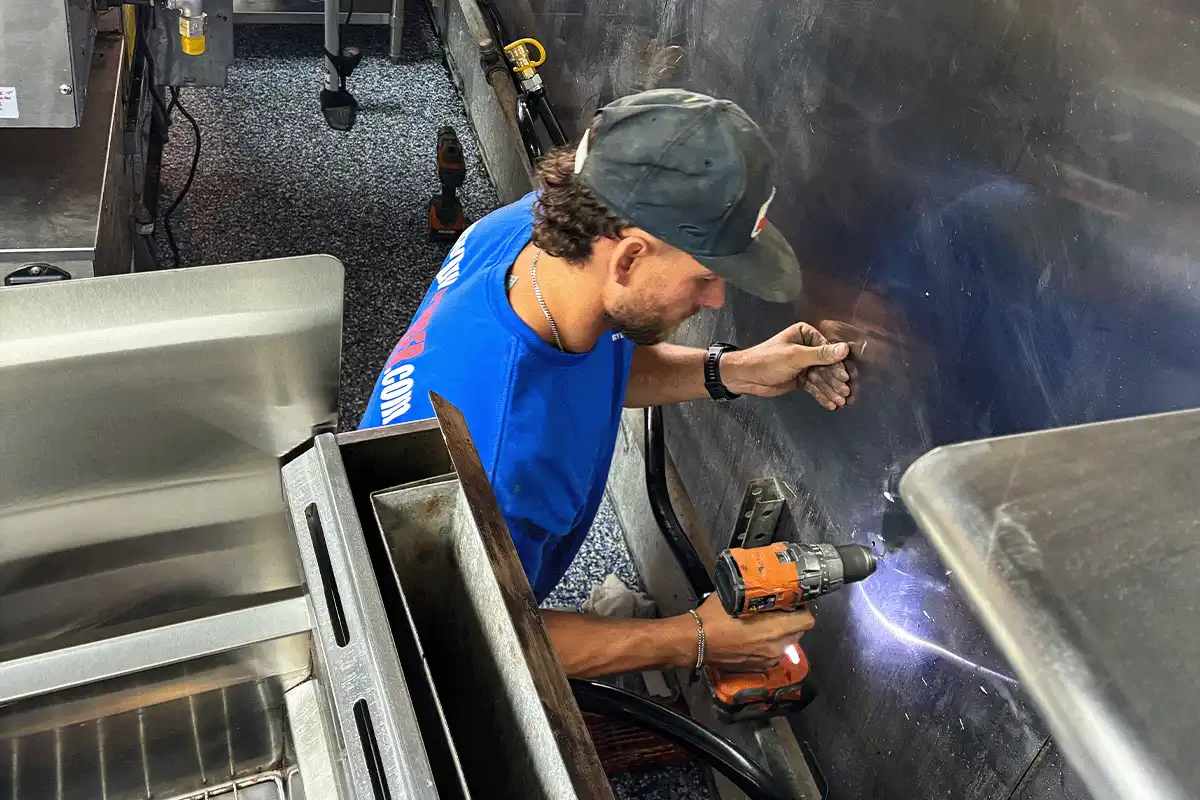 edp-tampa-commercial-plumbing-kitchen-repair-2026 EVERYDAYPLUMBER.com technician performing commercial kitchen plumbing repair in Tampa restaurant — EVERYDAYPLUMBER.com Tampa