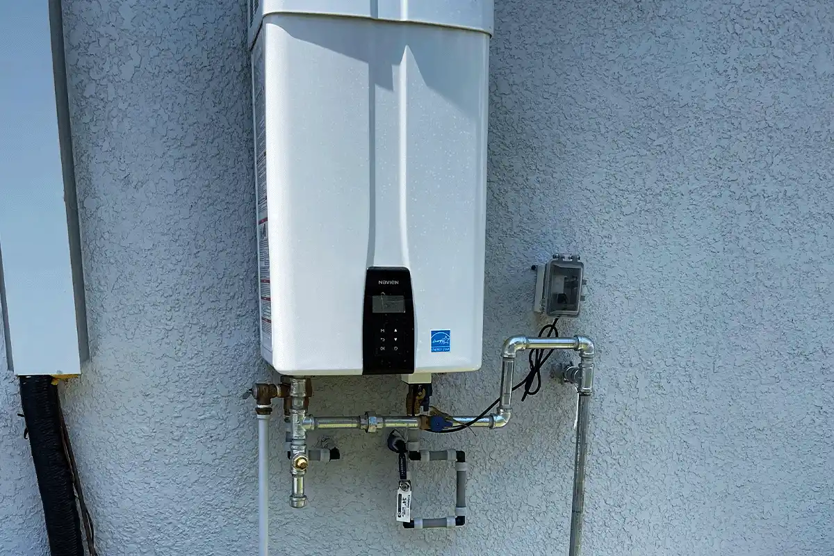 edp-tampa-residential-plumbing-tankless-water-heater-installation-2026 Navien tankless water heater installed on exterior wall of Tampa home — residential plumbing services — EVERYDAYPLUMBER.com Tampa