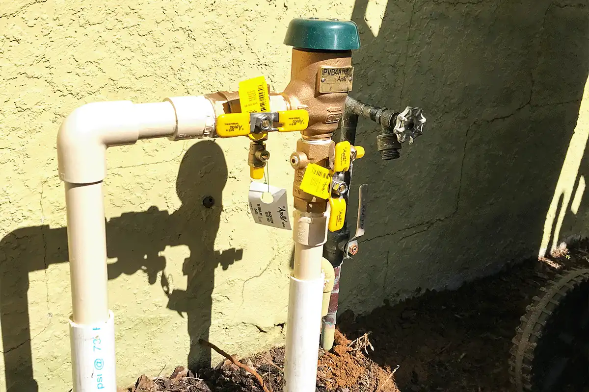 Backflow preventer assembly with test tags outside a Tampa Bay home — residential backflow testing — EVERYDAYPLUMBER.com Tampa Bay