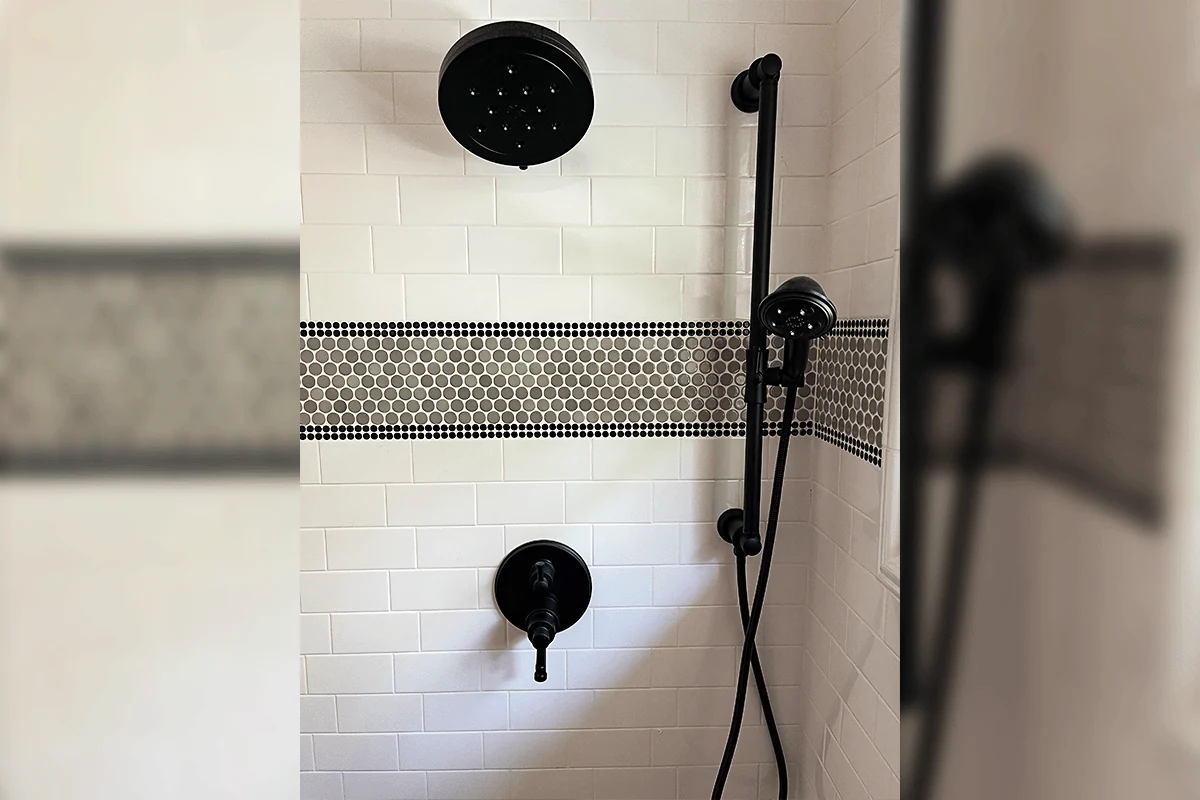 edp-black-rainfall-shower-valve-2026 Black finish rainfall shower head and handheld with penny tile accent — shower valve installation — EVERYDAYPLUMBER.com Tampa Bay