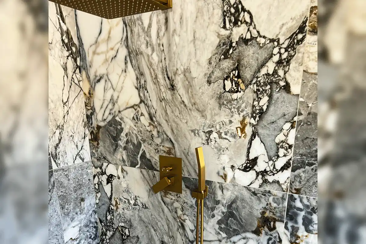 edp-brass-rainfall-marble-valve-2026 Brass rainfall shower head and handheld on dramatic marble tile — shower valve installation — EVERYDAYPLUMBER.com Tampa Bay