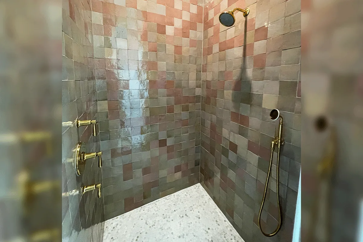 edp-brass-valve-terracotta-tile-2026 Brass cross-handle shower valve set on terracotta zellige tile — shower valve repair — EVERYDAYPLUMBER.com Tampa Bay