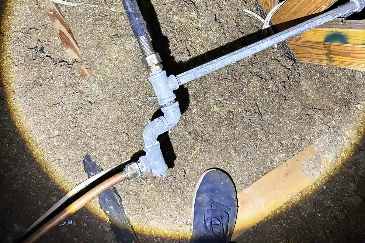 edp-gas-line-crawlspace-connection-2026 Gas line elbow fitting and connection point in a home crawlspace — gas plumbing services — EVERYDAYPLUMBER.com Tampa Bay