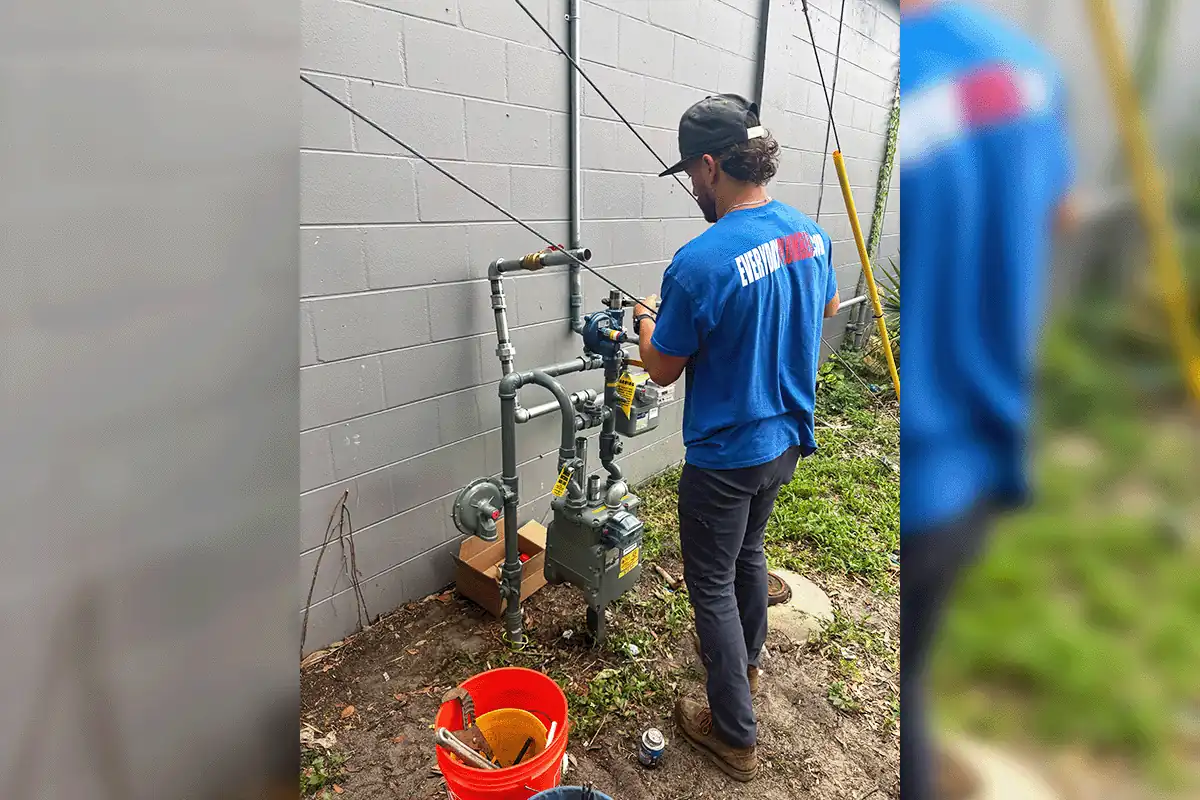 Technician installing a natural gas line at a Tampa Bay property