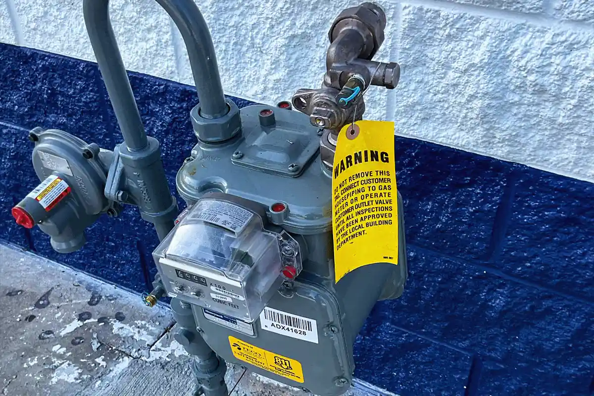 edp-gas-meter-inspection-tag-2026 Gas meter with official inspection warning tag attached — licensed and permitted gas plumbing — EVERYDAYPLUMBER.com Tampa