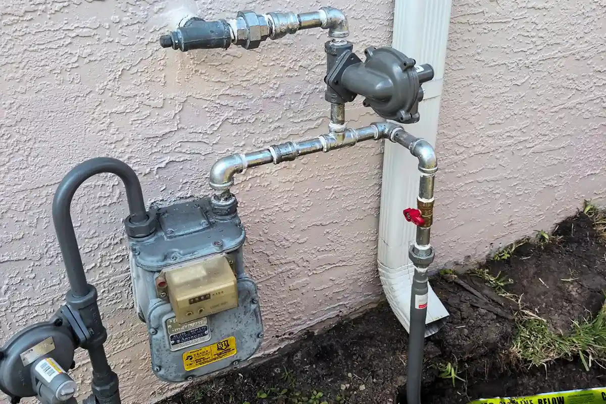 edp-gas-regulator-shutoff-valve-2026 Gas meter, regulator, and shutoff valve assembly on home exterior — gas line safety and code compliance — EVERYDAYPLUMBER.com Tampa