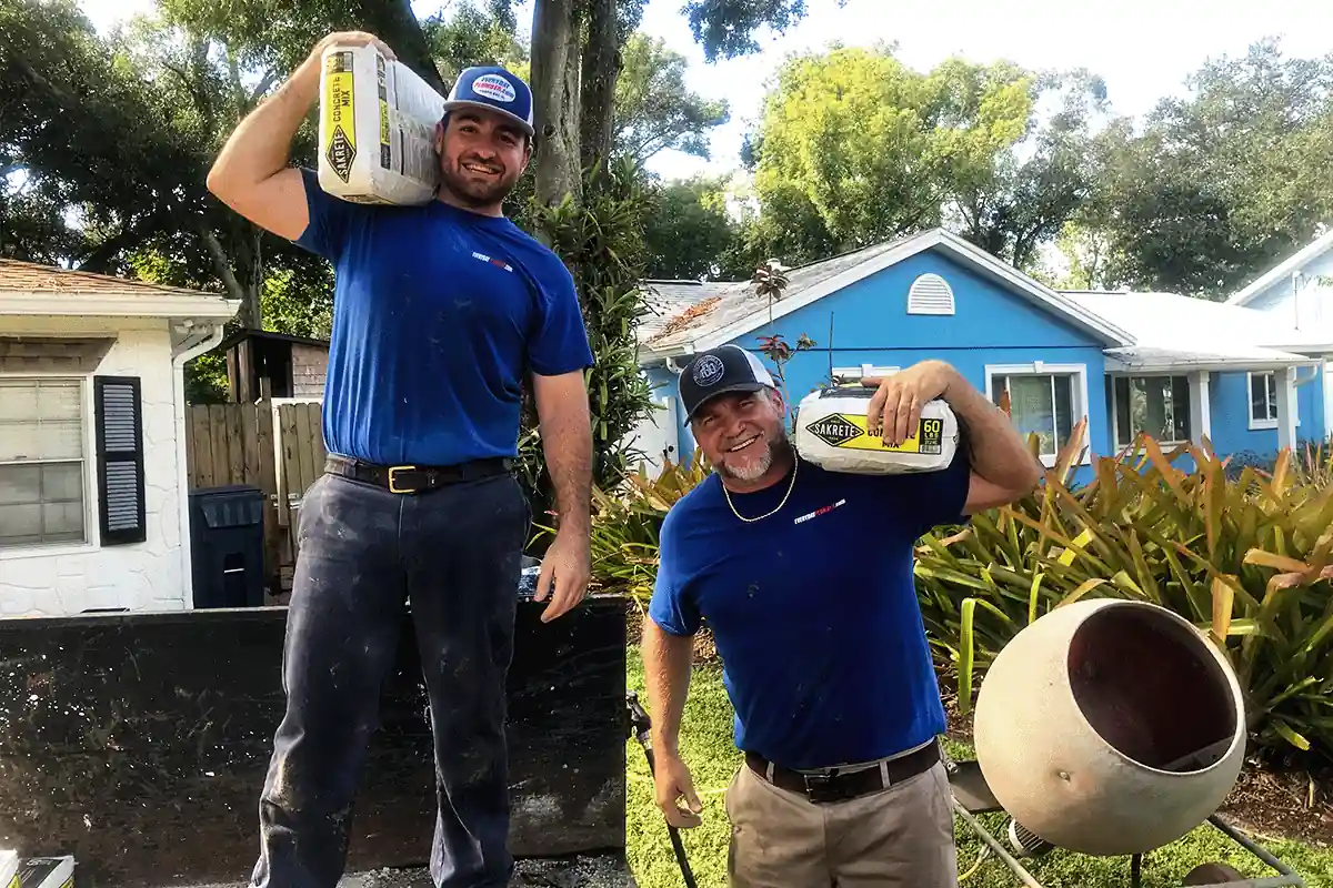 EVERYDAYPLUMBER.com plumbing technicians carrying concrete mix for a slab repair — residential plumbing team — EVERYDAYPLUMBER.com Tampa Bay