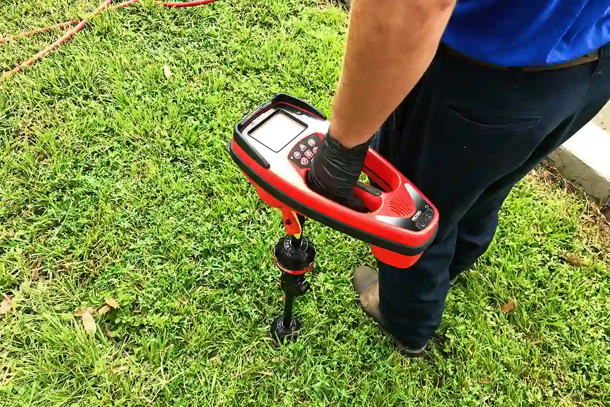 edp-sewer-line-electronic-locator-2026 Plumber using an electronic locator to pinpoint a sewer line issue found by camera — sewer camera inspection process — EVERYDAYPLUMBER.com Tampa Bay