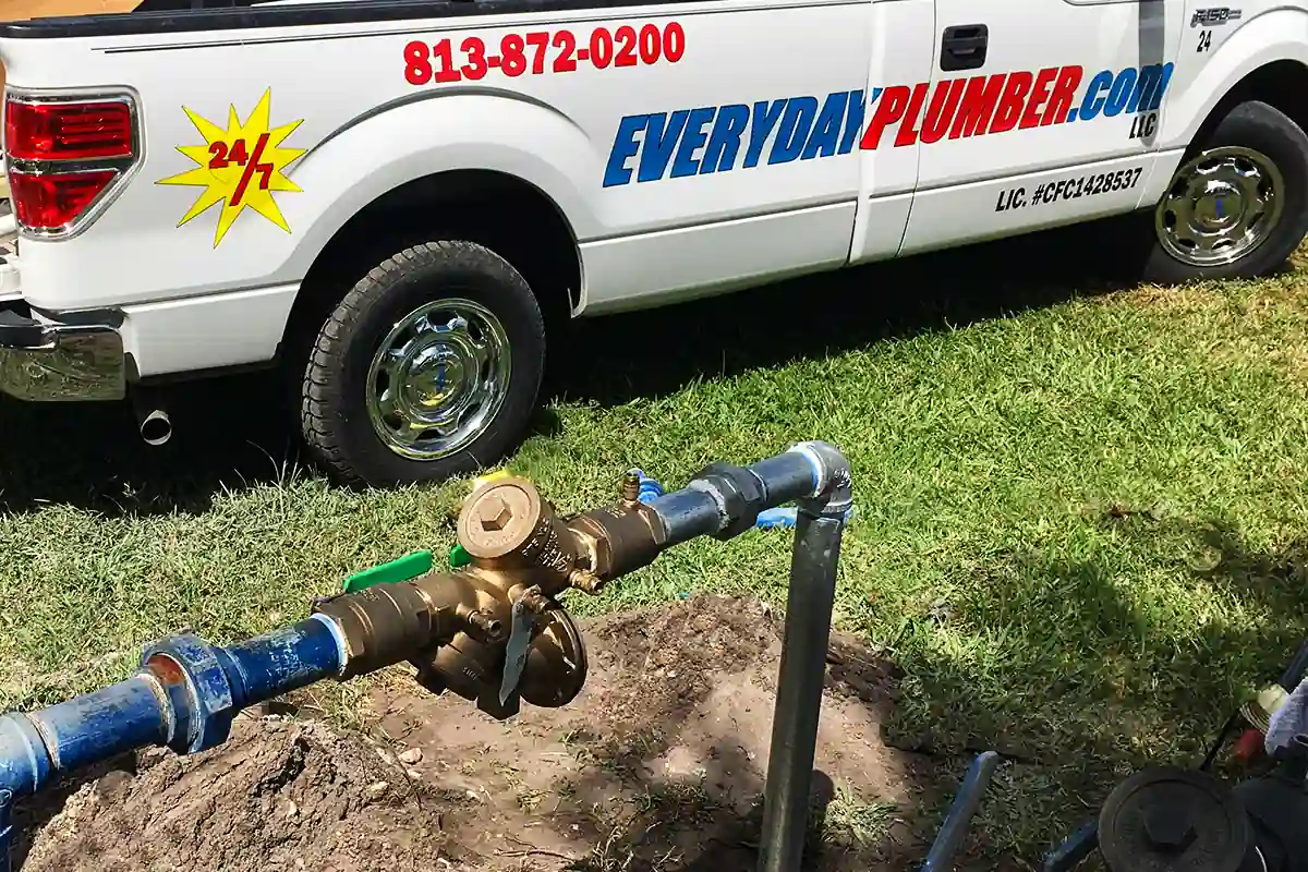 edp-tampa-backflow-repair-featured-2026 EVERYDAYPLUMBER.com service truck beside a newly installed residential backflow preventer — backflow installation — EVERYDAYPLUMBER.com Tampa Bay